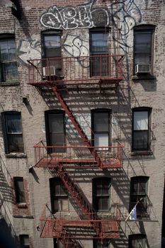 straight on view of exterior steel fire escape on tenement building.  lower east side, new york city