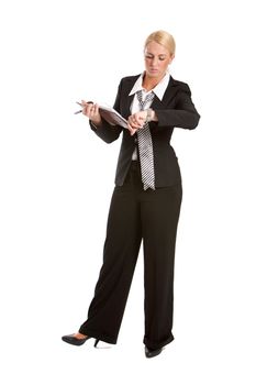 Business woman checking the time on her watch while standing