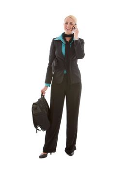 Attractive young business woman standing on the phone 