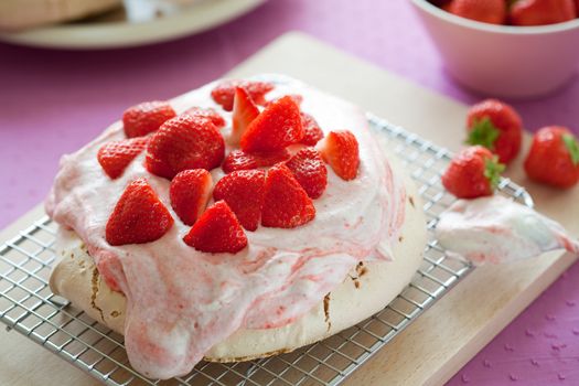 Delicious strawberry pavlova topped with fresh cream and strawberries