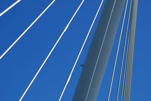 suspension bridge support cables against a blue sky