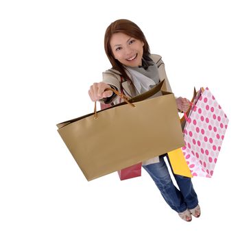 Happy shopping woman show her bags and smiling isolated over white.