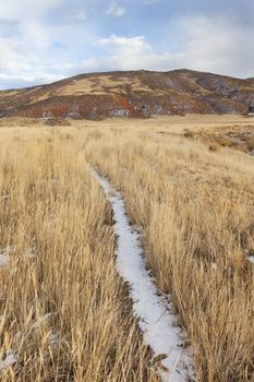 cattle trail in Red Mountain Open Space in northern Colorado (Larimer County), fall scenery with dry grass and soem snow