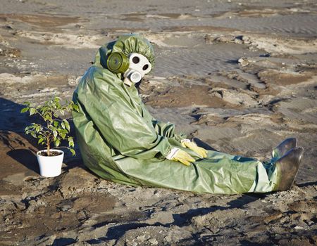 Environmental scientist and a plant in a pot, in the desert