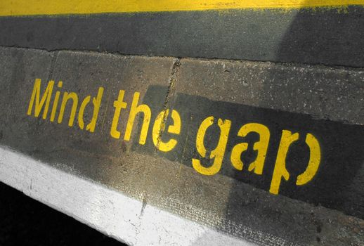 mind the gap sign on a railway or subway platform