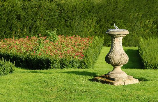 stone sundial in a summer garden