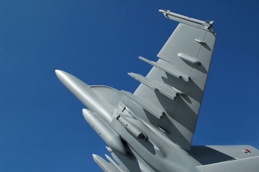 large scale replica fighter jet against blue sky