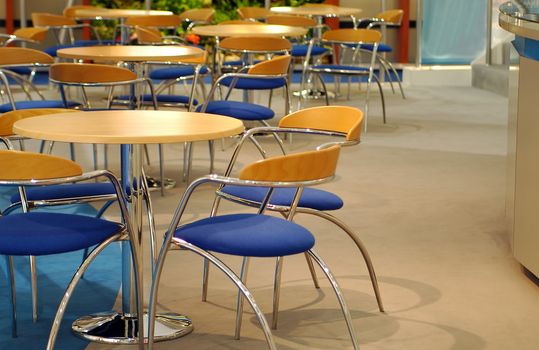 generic meeting place interior with wooden tables and chrome chairs