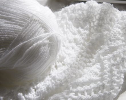 white wool and knitting showing the detail of the knitted work