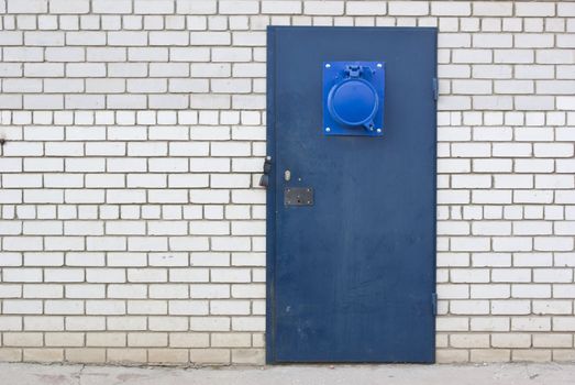 the blue steel door in the brick white