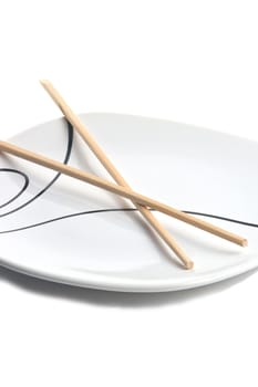 Wood chopsticks and asian style plate against white background