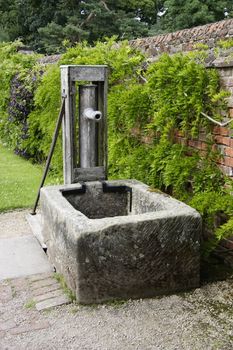 old fashioned water pump in a garden