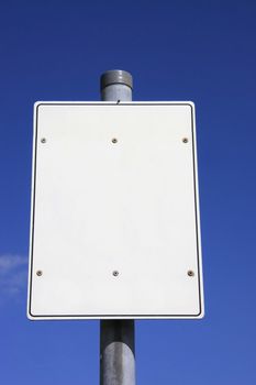 white signpost against a blue sky
