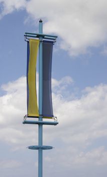 yellow and blue banner against a sky background