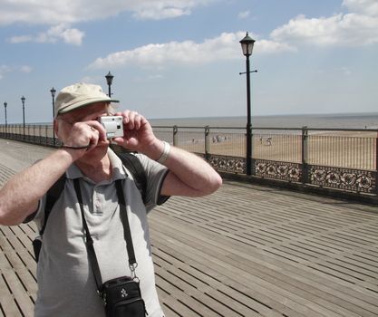 amateur photographer with his point and shoot camera taking snapshots