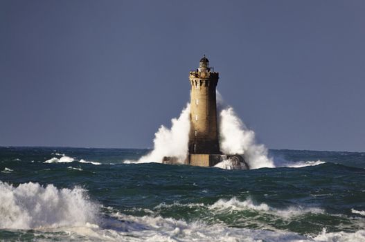 Lighthouse called "Le phare du four" in Tremazan in Brittany, France during storm in November