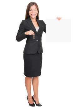 Real estate agent showing blank sign while holding house keys. Beautiful smiling woman (mixed Caucasian / Asian) isolated on white background in full body.