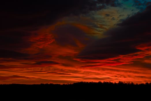 the dark red sunrise background with clouds