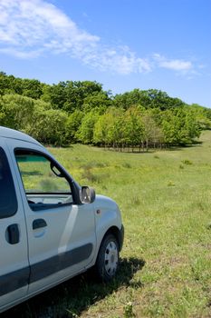 Detail of family car in the fresh green field