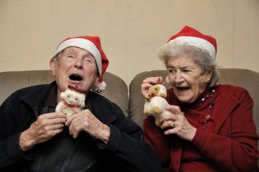 Old senior couple with santa hats celebrating christmas