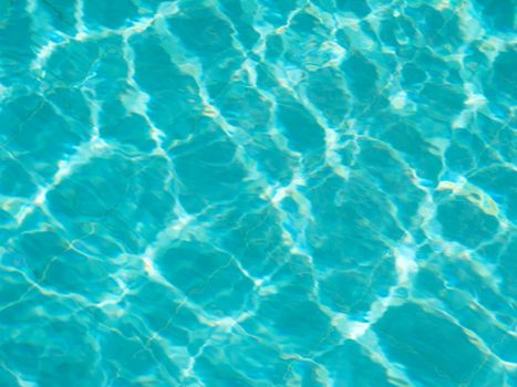 Blue pool water with sun reflections
