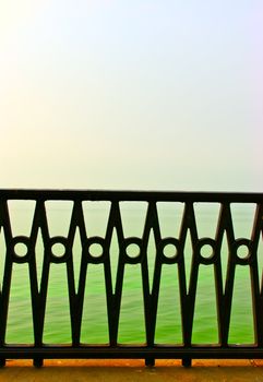 the beautiful forged fence against the sea