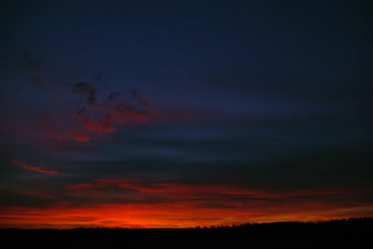 the dark red sunrise background with clouds