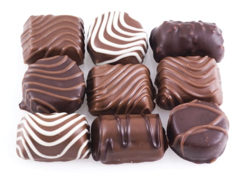 Nive belgian chocolates on a white background.