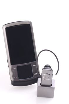 Mobile phone with wireless headset on a white background.