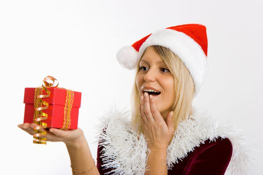 admiring a girl in a Christmas hat holding a New Year gift

