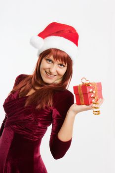 admiring a girl in a Christmas hat holding a New Year gift
