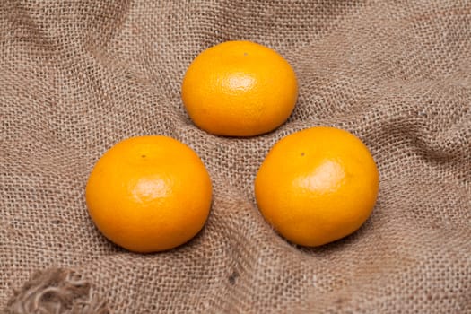 Three tangerines on sackcloth with limited by depth to sharpnesses