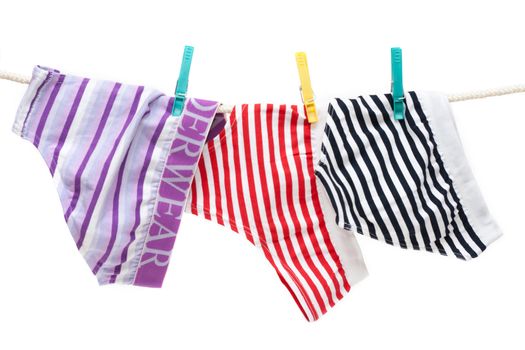 Colour undershorts hung on linen rope with clothes-peg