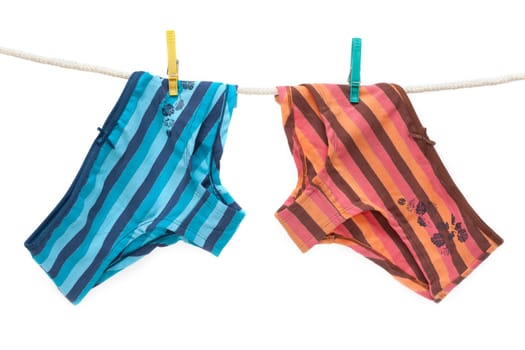 Feminine colour panties hung on linen rope, isolat
