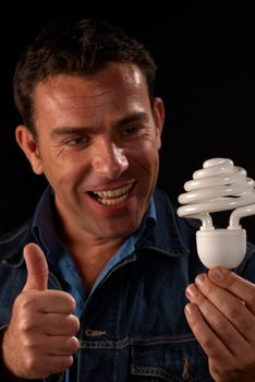 Attractive guy giving thumbs up to energy efficiency