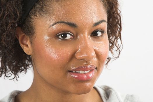 Beautiful woman with her face covered in sweat after working out