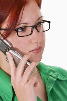 Close-up image of a redheaded girl using a mobile phone. Slective focus on her left eye.Shot with Canon 70-200mm f/2.8L IS USM