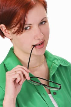 Portrait of a young redheaded girl looking slick with the sidepiece of her glasses in her mouth.