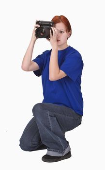 Redheaded girl taking photos with a DSRL camera. 
