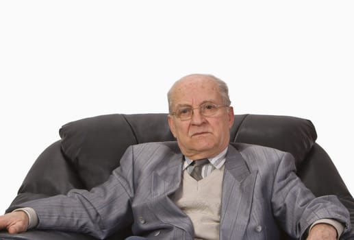 Portrait of a senior man sitting in an armchair.Shot with Canon 70-200mm f/2.8L IS USM
