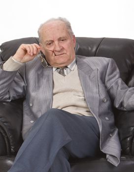 Portrait of a senior man thinking deeply in his office armchair.