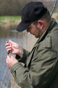 Man preparing his fishingrod