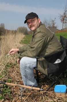 Fisherman smoking a cigarette while waiting for the fish to bite