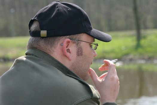 Fisherman staring over the water to see if the fish will bite