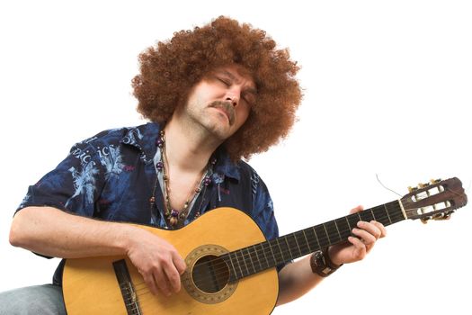 Hippy with old guitar totally into his music