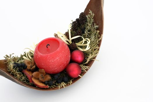 Red candle in a decorated wooden bowl