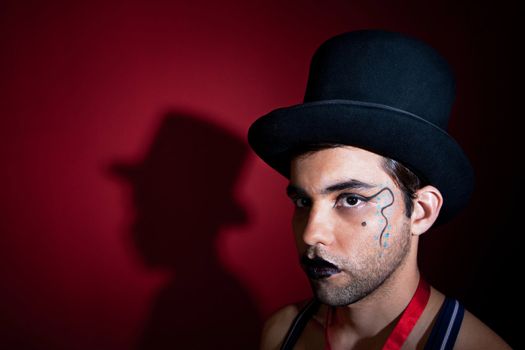 Man in top hat with shadow on the wall