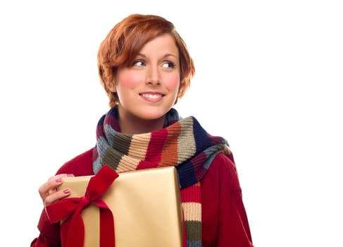 Pretty Red Haired Girl with Scarf Holding Wrapped Gift Looking Off to the Side Isolated on a White Background.