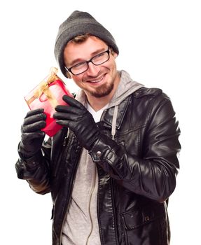 Warmly Dressed Handsome Young Man Holding Wrapped Gift To His Ear Isolated on a White Background.