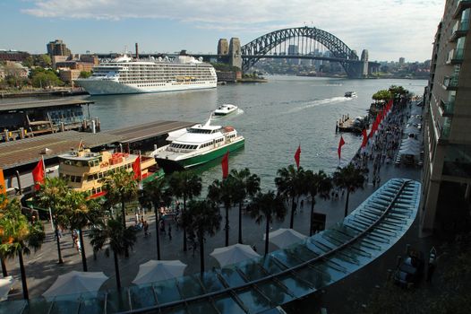 Sydney's Circular Quay, big white boat anchoring, Harbour bridge in background, no advertisment in picture